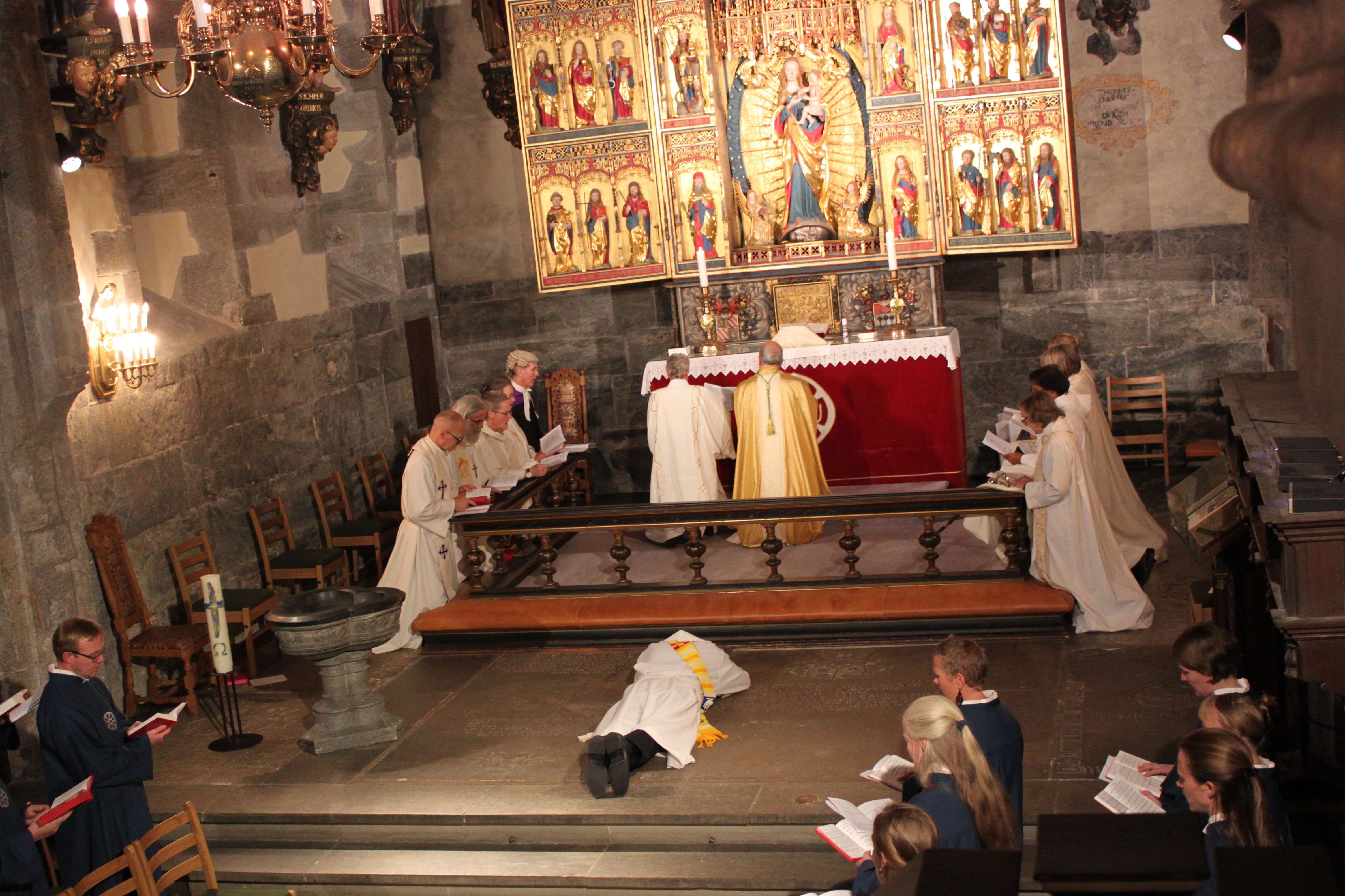 A clergy member laying face down at an ordination.