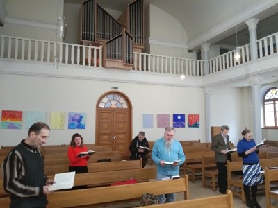 Congregation singing from a book.