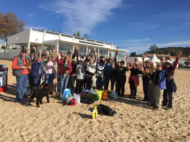 A group on the beach after a beach clean up event.