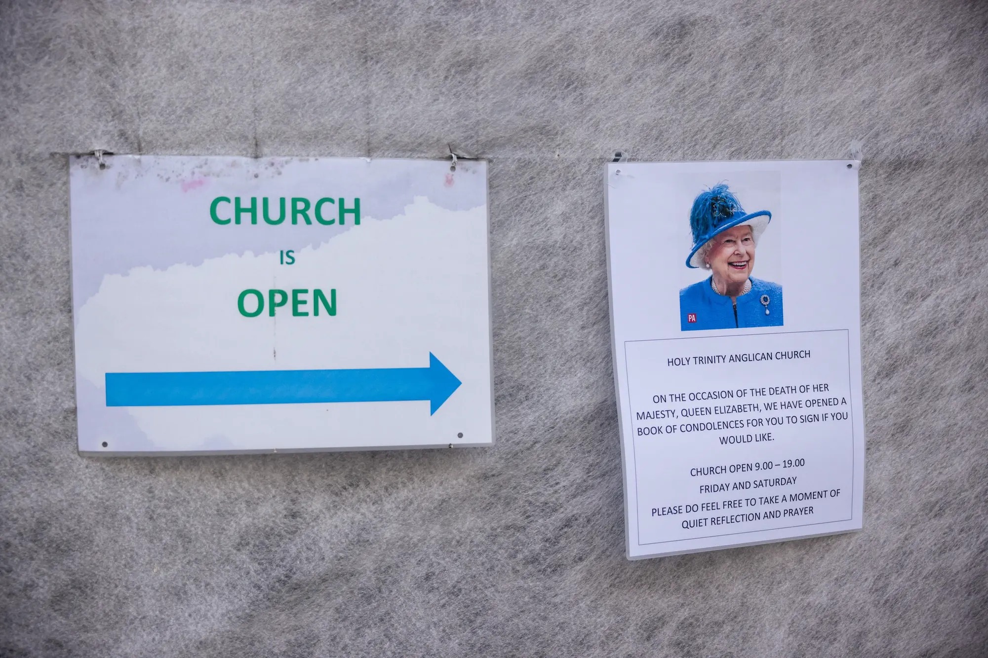 A sign stating the church is still open despite the queens passing.