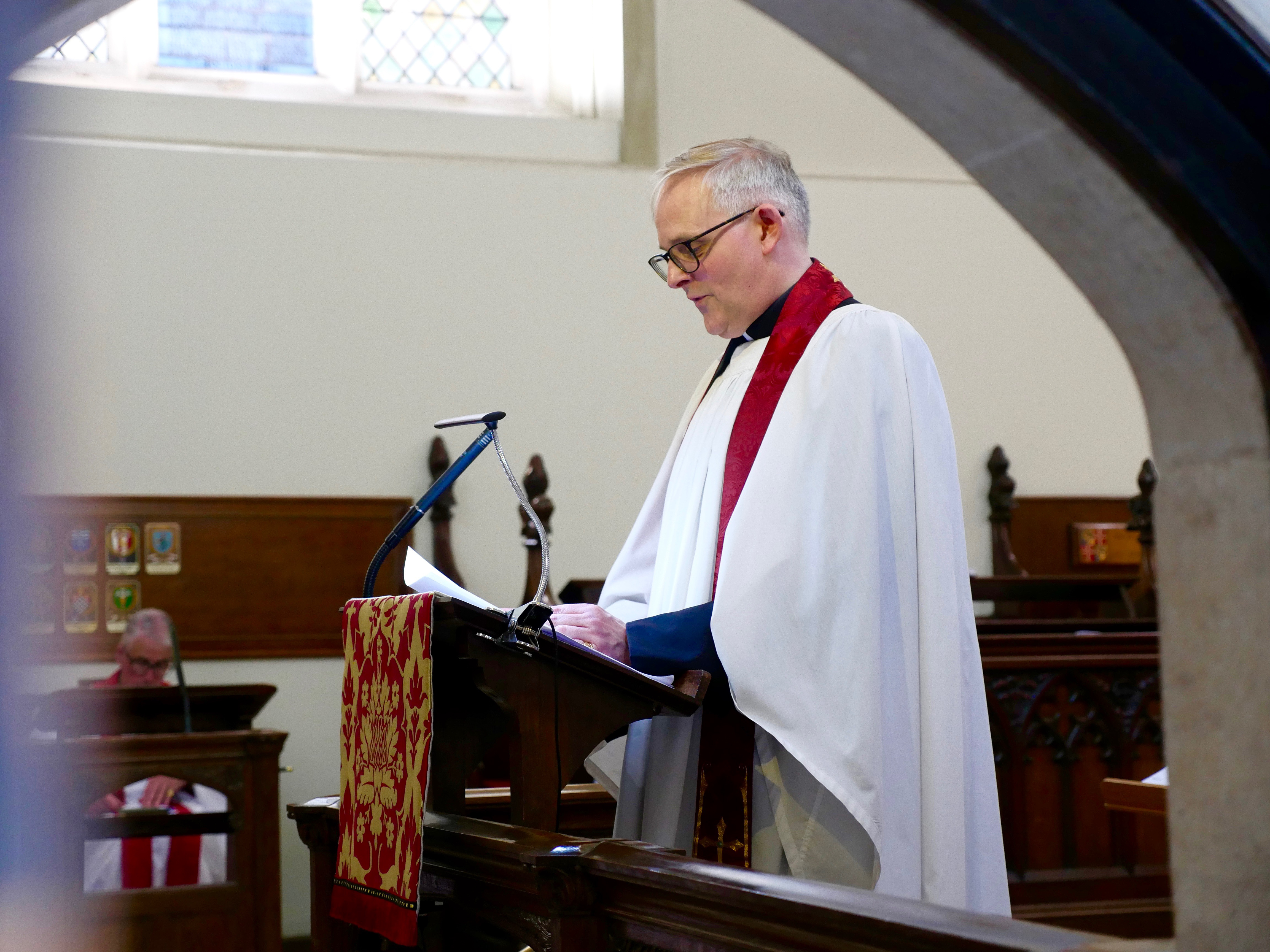 A clergy member reads at the Chapel of Savoy.