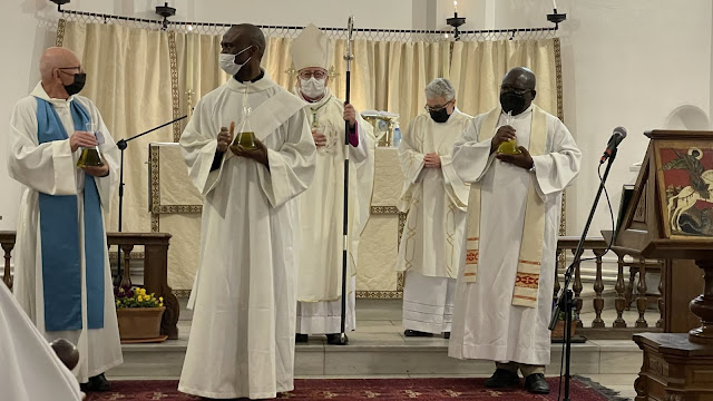 Clergy holding the oils at Chrism Mass.