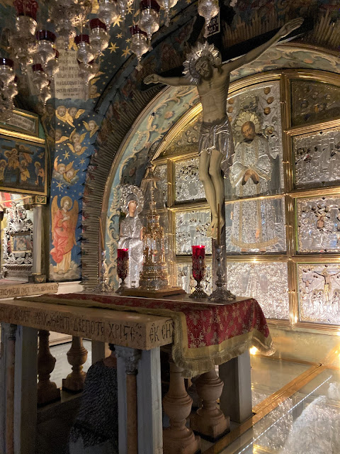 An ornate and aged altar with depictions of Jesus on the cross.