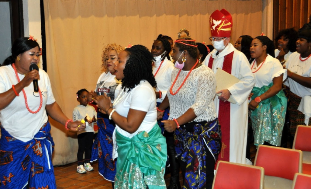 Bishop Robert accompanied into church by dancing girls.