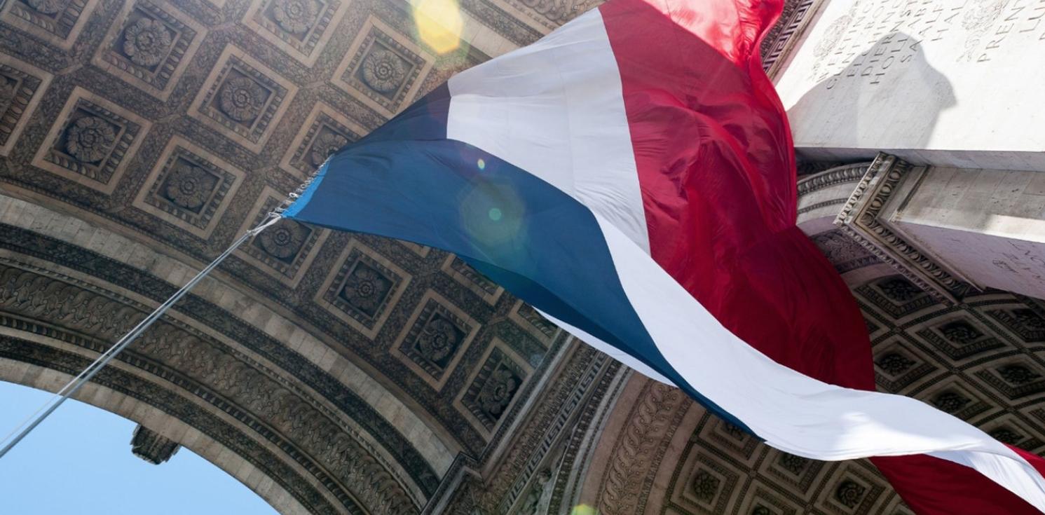 A french flag flying in the wind.