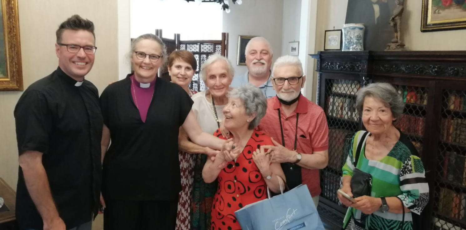 A group of smiling members of the Holy Cross church.