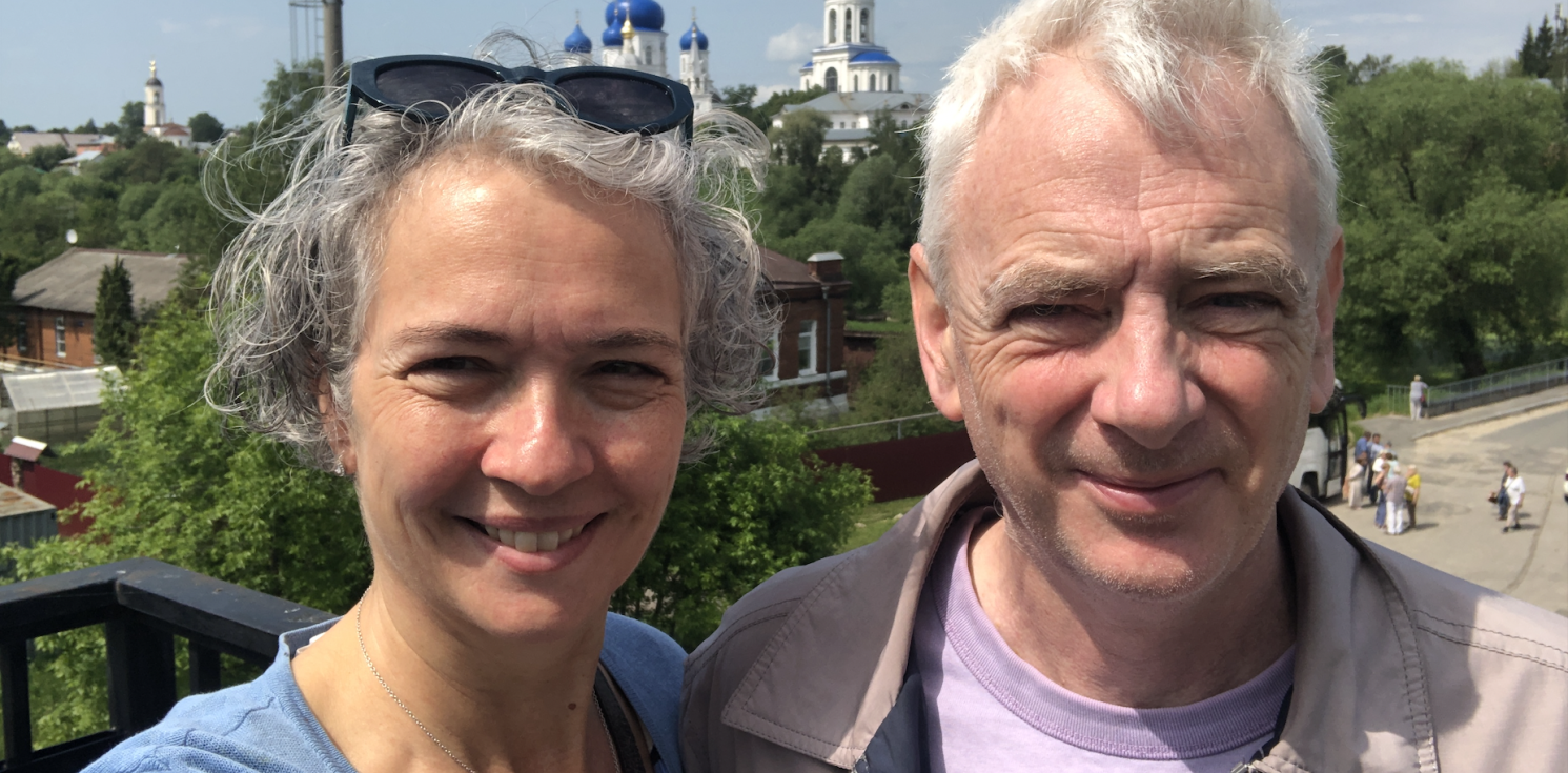 Alison and Malcolm Rogers on a balcony with cityscape behind