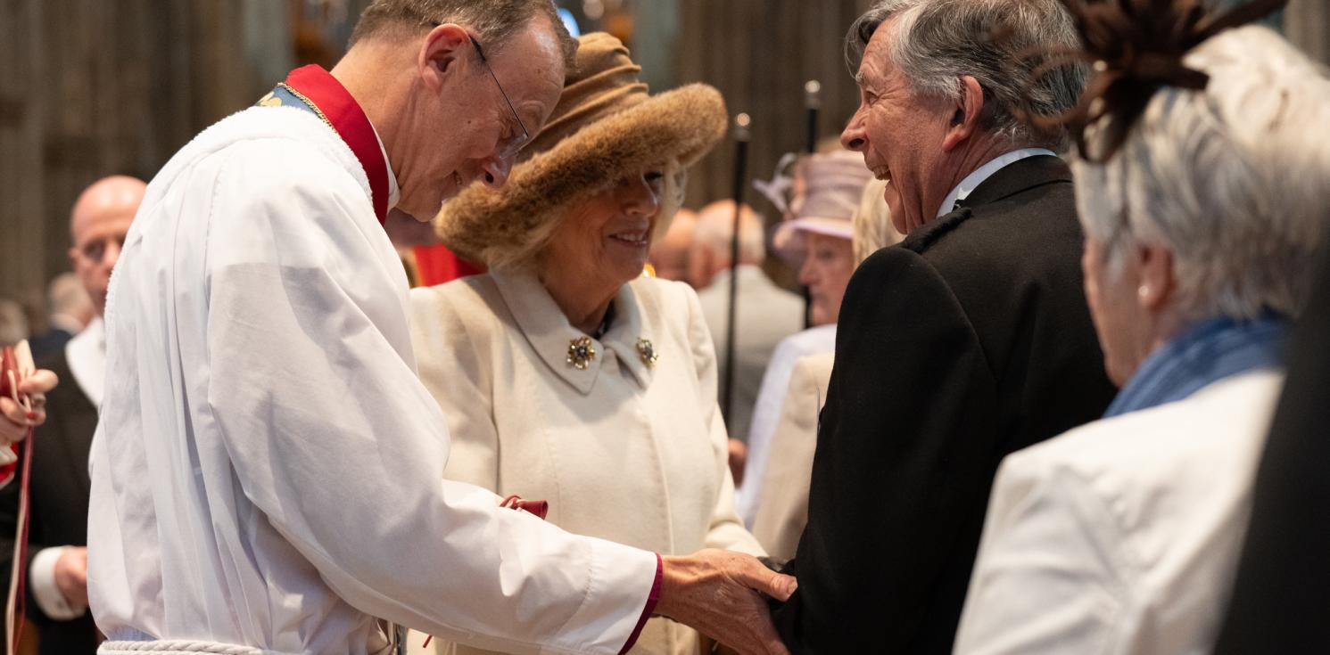 Queen Camilla laughs with a Maundy Thursday recipient 2024