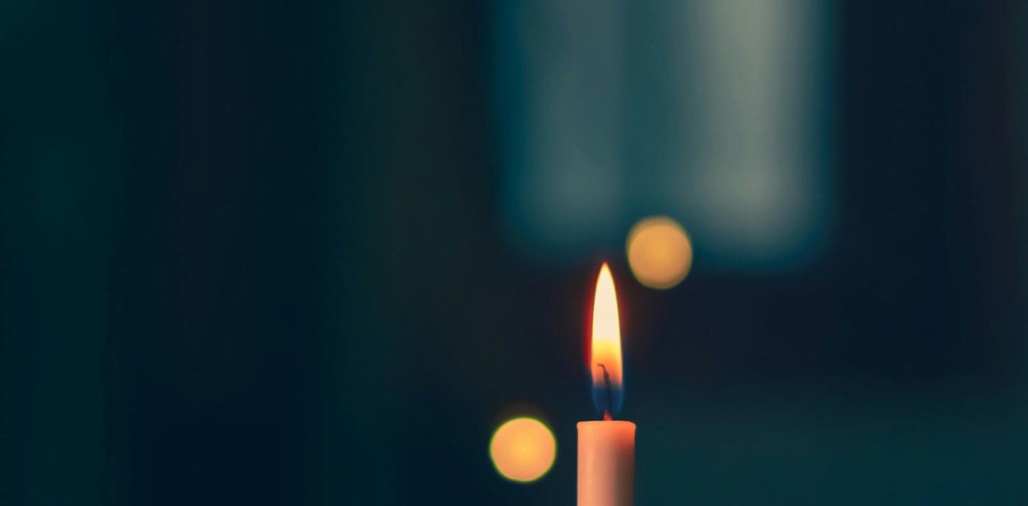 a picture of a candle in the darkness