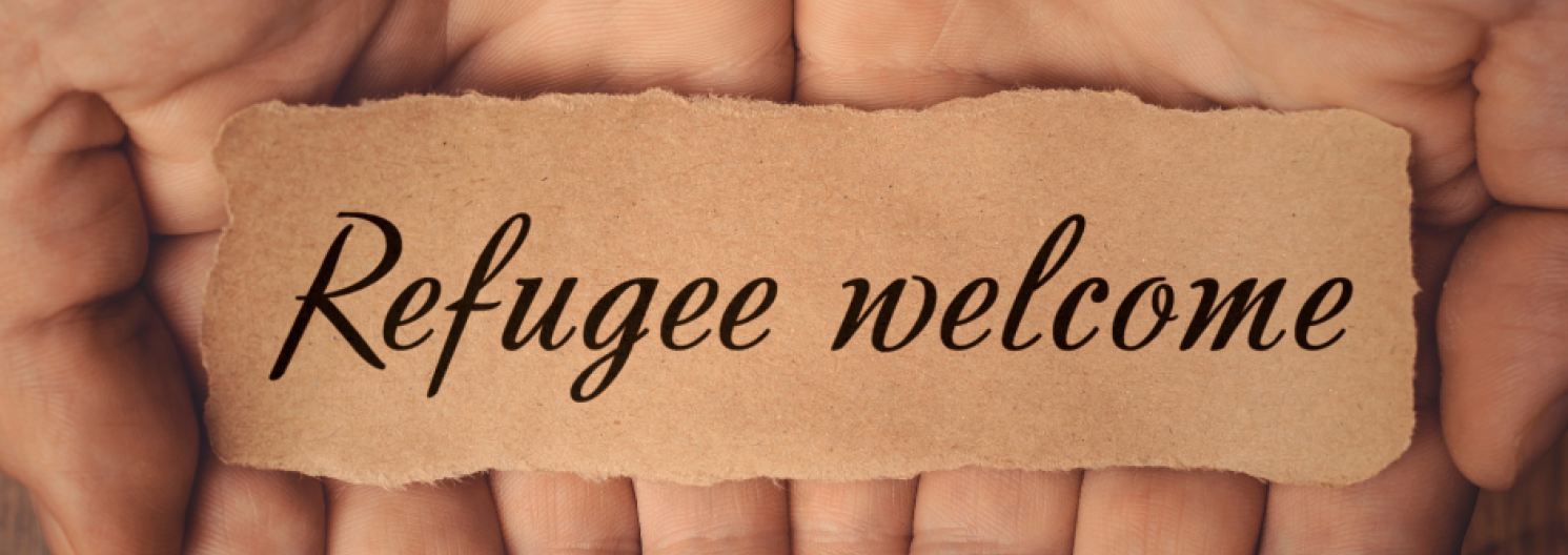 strip of paper with refugees welcome on it