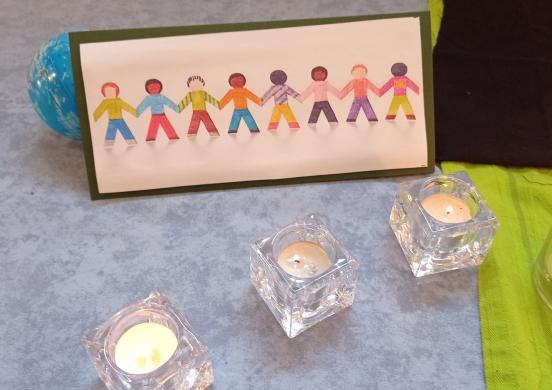 drawing of people holding hands and tea light candles around