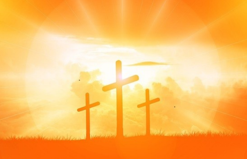 Three orange crosses on a hill.