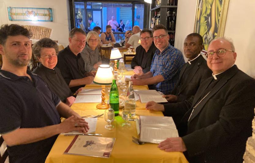 Bishop David and Clergy enjoying a meal together.