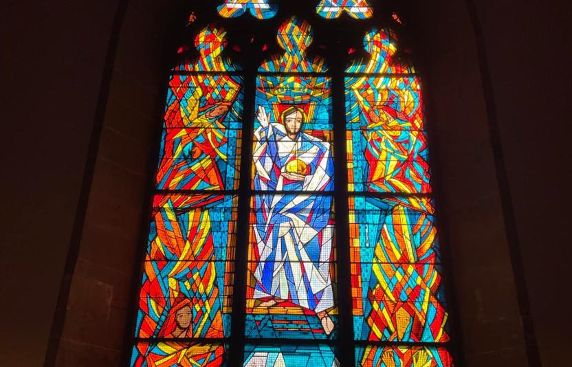 a stained glass window in the church building 