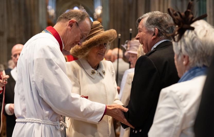 Queen Camilla laughs with a Maundy Thursday recipient 2024