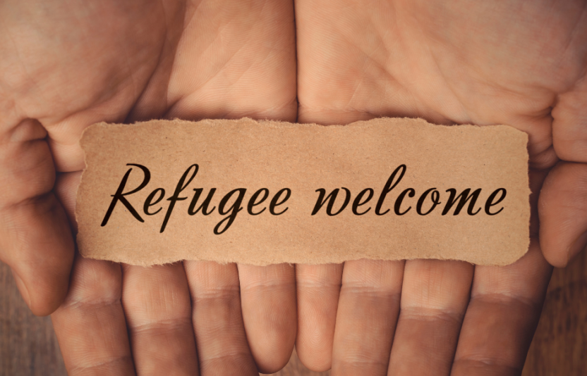 strip of paper with refugees welcome on it