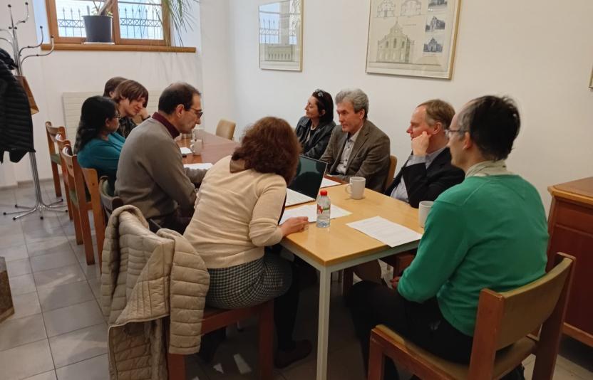 A group of people sit round a table