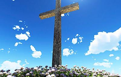 A large cross infront of a blue sky.