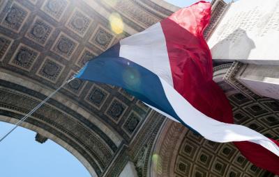 A french flag flying in the wind.
