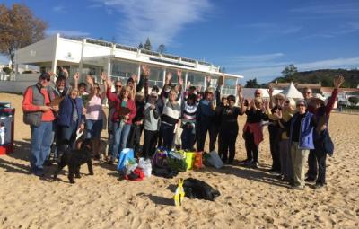 A group on the beach after a beach clean up event.