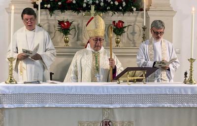 Bishop David reads at the centenary celebrations.