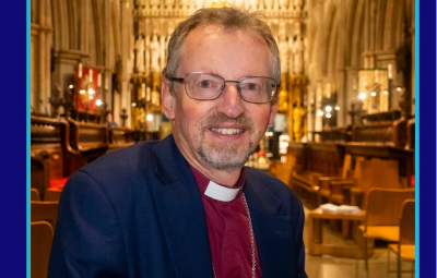 Bishop Robert smiles to camera