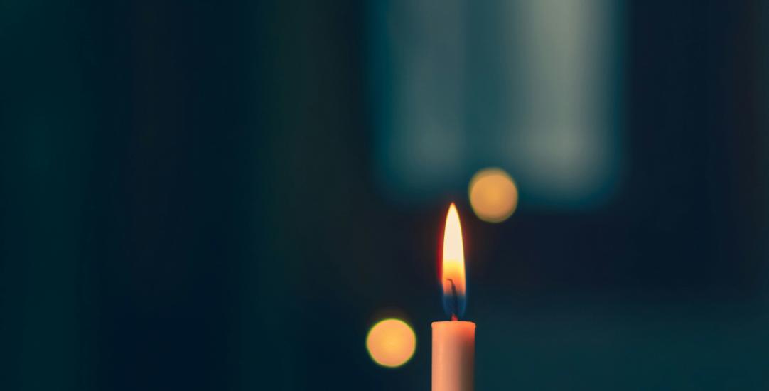 a picture of a candle in the darkness